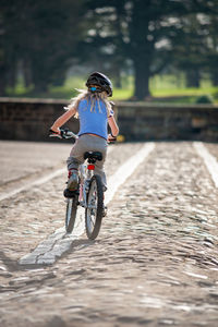 Rear view of woman riding bicycle