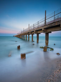 Pier over sea against clear sky