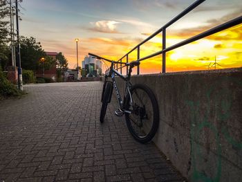 Bicycle against sky during sunset