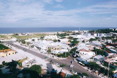 High angle view of townscape by sea against sky