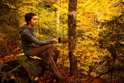 Young man standing in forest