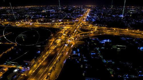 High angle view of city lit up at night