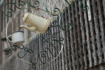 Cup and kettle on railing