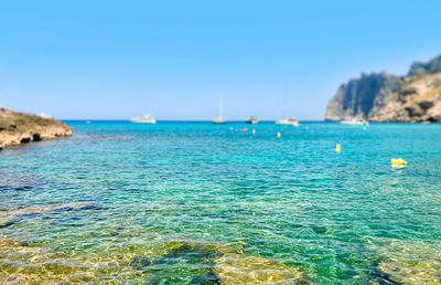 Scenic view of sea against clear blue sky