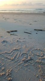 Close-up of footprints on sand at beach