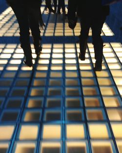 Low section of people standing on escalator