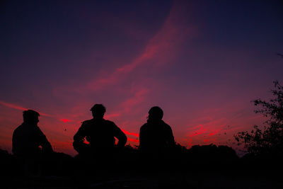 Silhouette people against sky during sunset