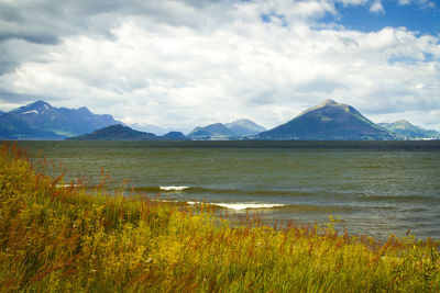 Scenic view of lake and mountains against sky