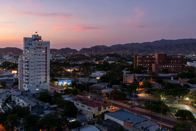 High angle view of buildings in city against sky during sunset