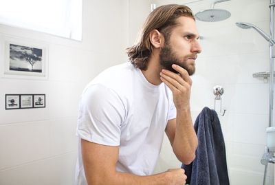 Bearded young man at domestic bathroom