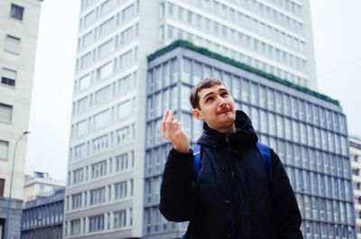 Young man standing in city