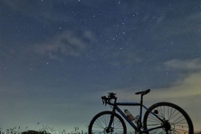 Bicycles against sky at night