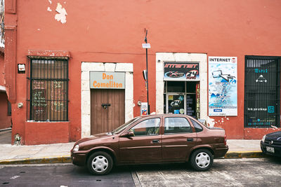 Car on street against buildings in city