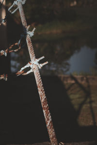 Close-up of rope tied up on metal fence