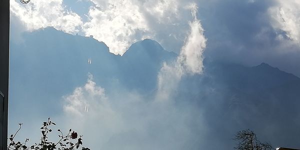 Low angle view of silhouette mountains against sky