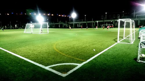 Illuminated lights on soccer field at night