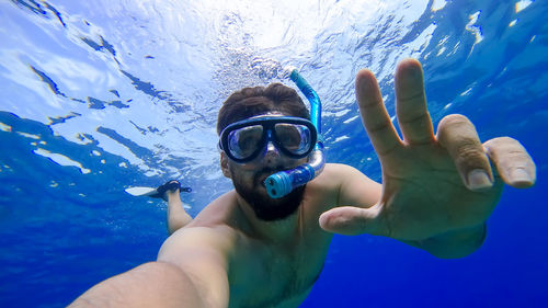 Low angle view of man swimming in sea