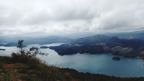 Scenic view of lake and mountains against sky