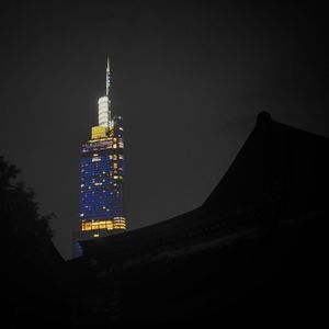 Low angle view of illuminated building against sky at night