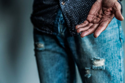 Midsection of man standing against blurred background