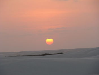 Scenic view of desert against sky during sunset