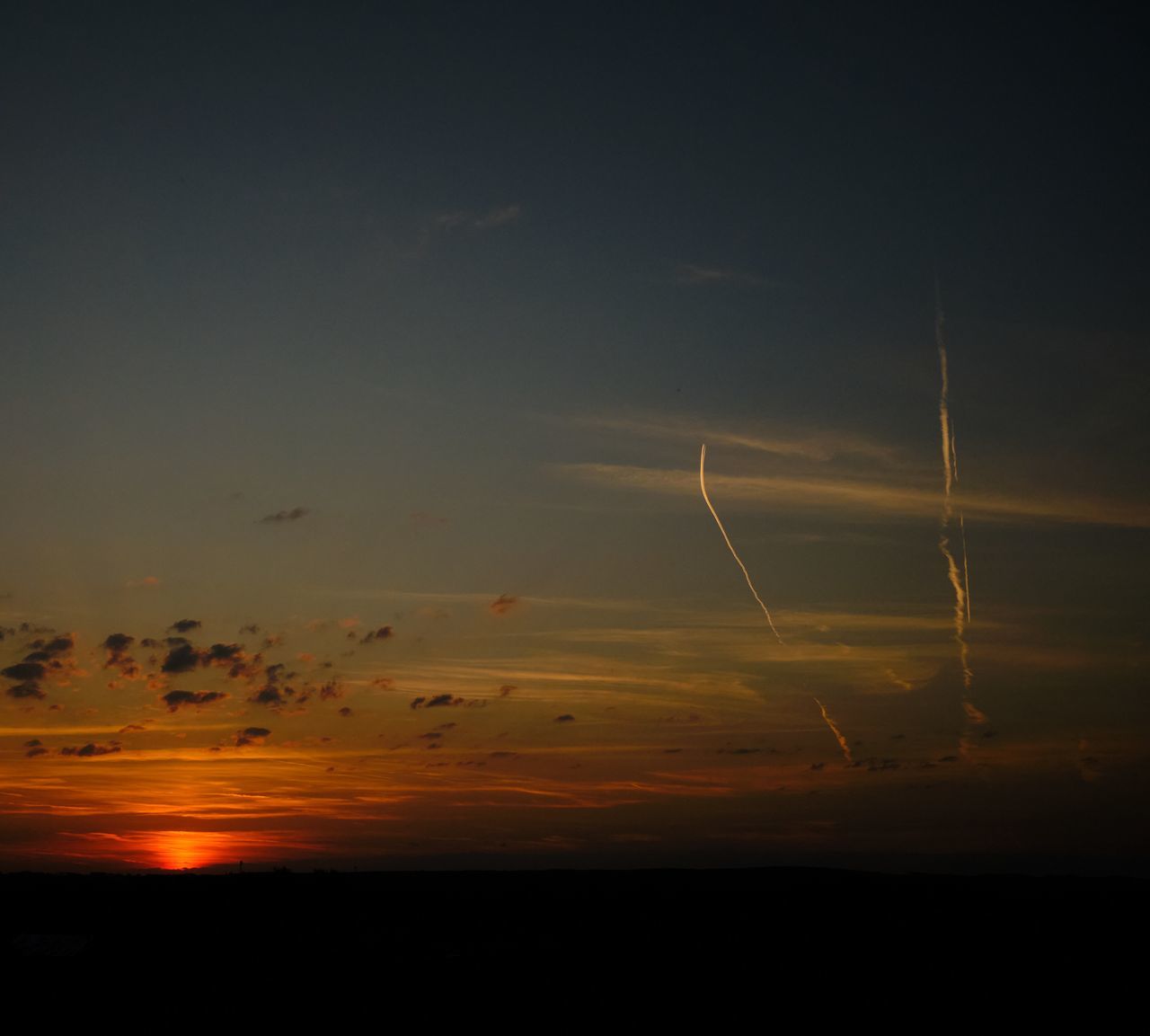 LOW ANGLE VIEW OF VAPOR TRAILS IN SKY