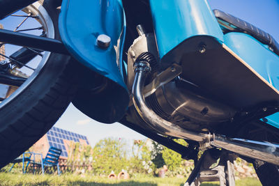 Close-up of metal wheel on field
