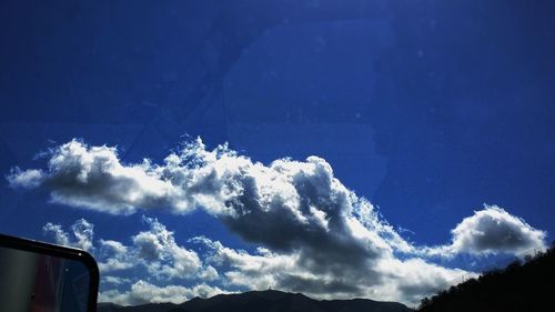 Low angle view of mountain against blue sky