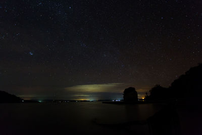 Scenic view of lake against sky at night