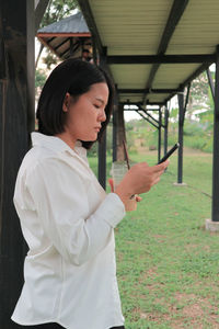 Side view of woman looking at camera