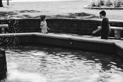 People standing by swimming pool