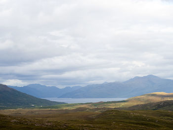 Scenic view of mountains against cloudy sky