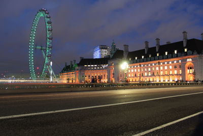 Illuminated ferris wheel at night
