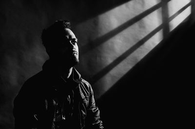 Young man in darkroom