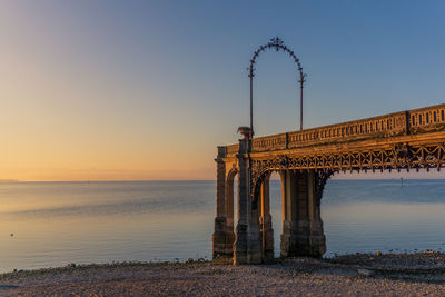 View of bridge over sea against sky during sunset