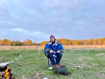 Rear view of man with dog on field