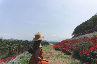 Side view of woman wearing hat against trees