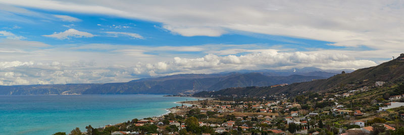 Panoramic shot of townscape by sea against sky