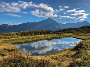 Scenic view of lake and mountains against sky