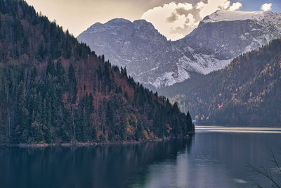 Scenic view of lake and mountains against sky during winter