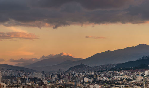 Cityscape against cloudy sky