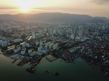 High angle view of buildings against sky during sunset