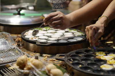 Midsection of woman preparing food on table