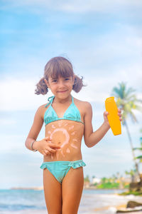 Portrait of smiling girl playing in sea