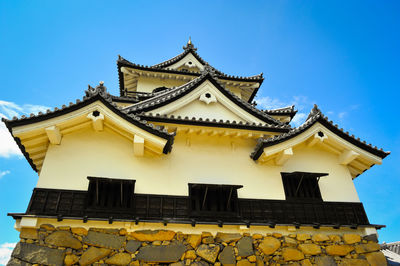 Low angle view of temple against clear blue sky