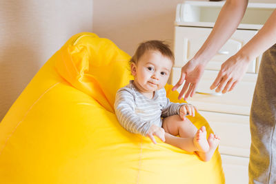 Cute baby girl lying on sofa at home