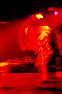 Rear view of woman playing at night
