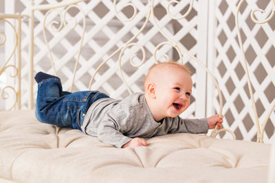 Cute baby lying on bed at home