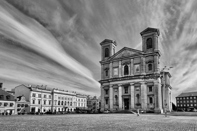 Buildings against cloudy sky