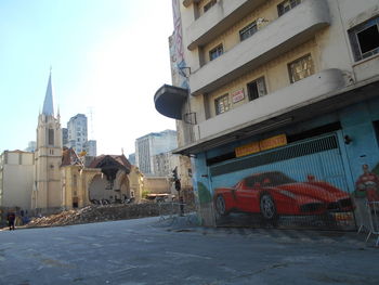 Street amidst buildings against sky